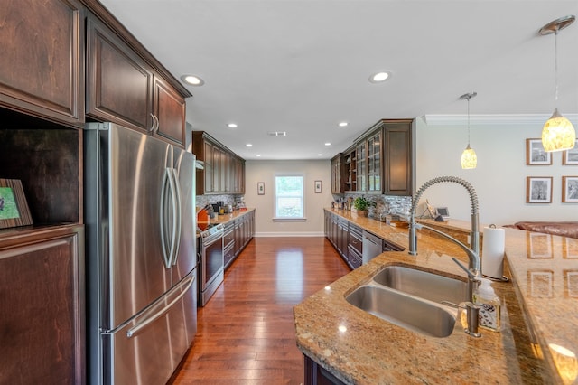 1178 Robin Kay Rd, Tallahassee, FL 32312 - kitchen with light stone countertops, appliances with stainless steel finishes, dark brown cabinets, backsplash, and recessed lighting
