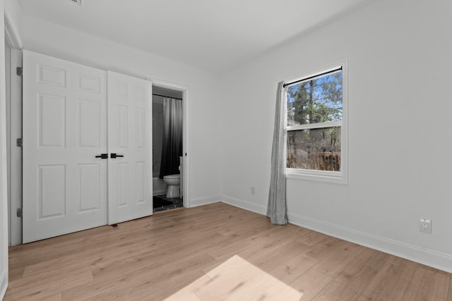 715 Caliark St, Tallahassee, FL 32304 - unfurnished bedroom featuring light wood-style flooring and ensuite bath