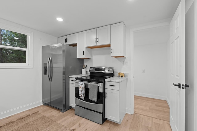 715 Caliark St, Tallahassee, FL 32304 - kitchen with stainless steel appliances, white cabinets, light wood-type flooring, recessed lighting, and light stone counters