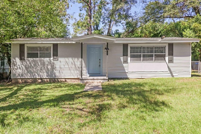 ranch-style home featuring a front yard