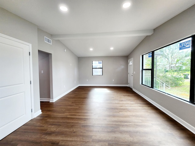 empty room with lofted ceiling with beams and dark hardwood / wood-style flooring