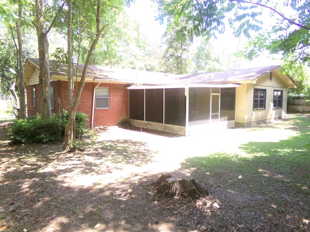 906 NE 1st St, Havana, FL 32333 - back of property featuring a sunroom and brick siding