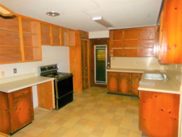 906 NE 1st St, Havana, FL 32333 - kitchen featuring electric range, open shelves, a sink, and light floors