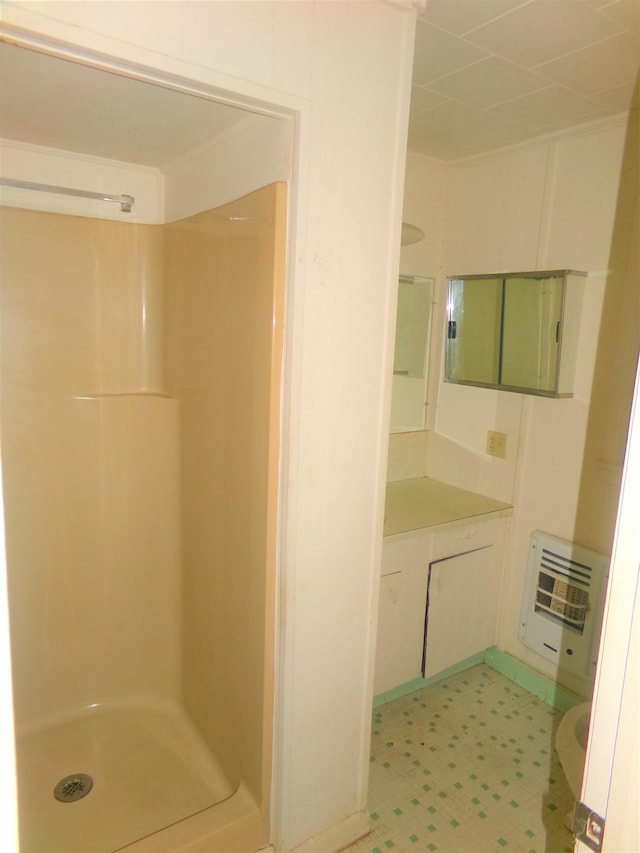 906 NE 1st St, Havana, FL 32333 - bathroom with heating unit, a stall shower, vanity, and tile patterned floors