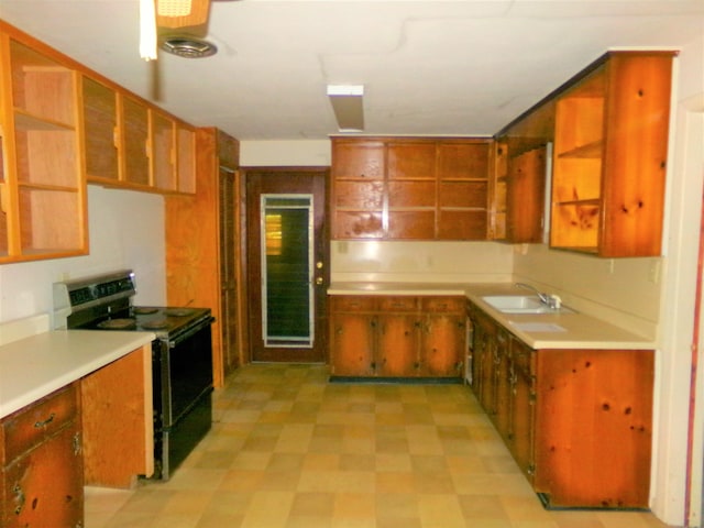 906 NE 1st St, Havana, FL 32333 - kitchen with black range with electric stovetop, open shelves, a sink, and light flooring