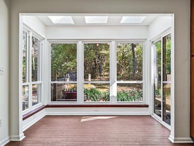 unfurnished sunroom featuring a skylight