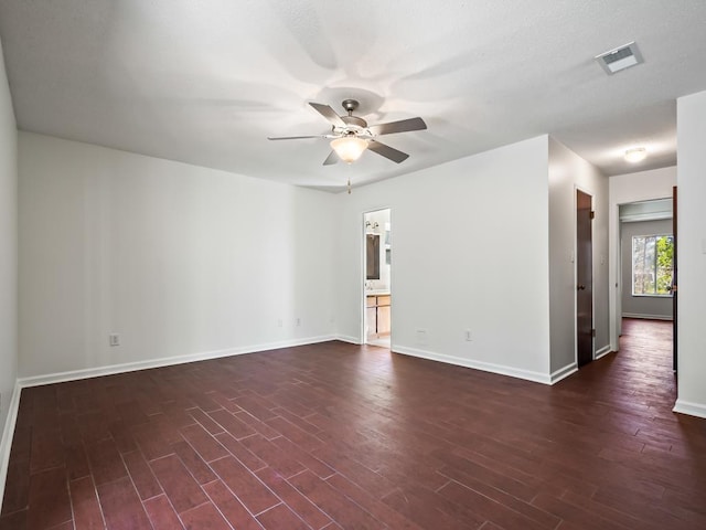 unfurnished room with dark wood-type flooring and ceiling fan