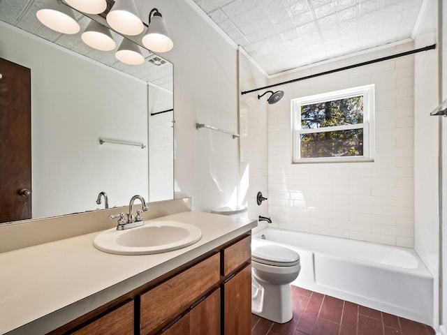 full bathroom with crown molding, tiled shower / bath, vanity, and toilet