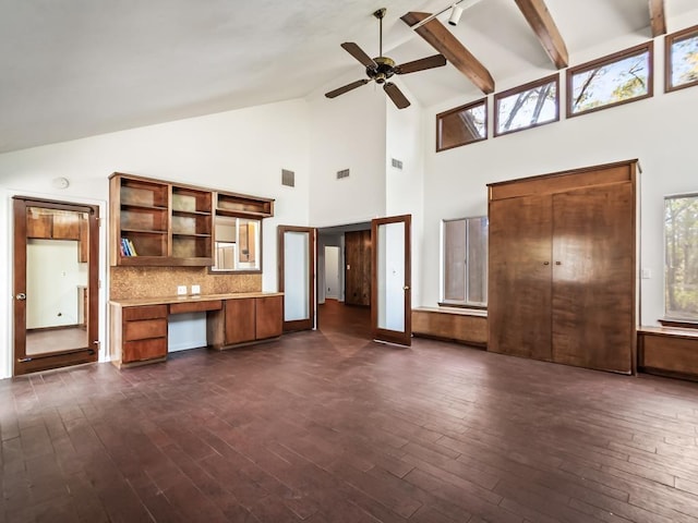 kitchen with a wealth of natural light, built in desk, and dark hardwood / wood-style floors