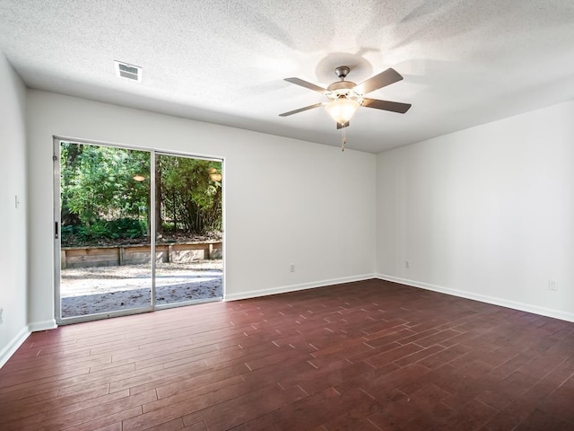 unfurnished room featuring dark wood-type flooring, a textured ceiling, and ceiling fan