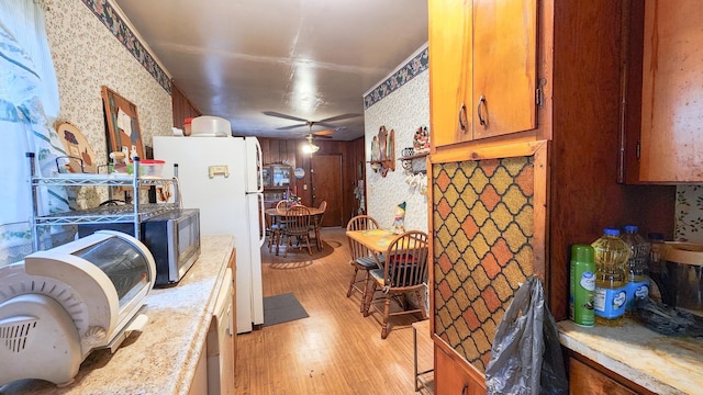 kitchen with ceiling fan and light hardwood / wood-style flooring