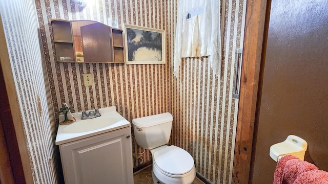 bathroom featuring toilet and vanity