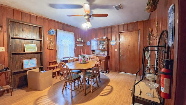 dining area with ceiling fan and light hardwood / wood-style flooring