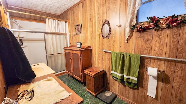 bathroom featuring vanity, wood walls, and curtained shower