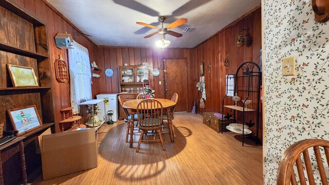 dining space featuring light wood-type flooring and ceiling fan