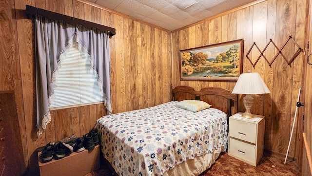 carpeted bedroom featuring wood walls