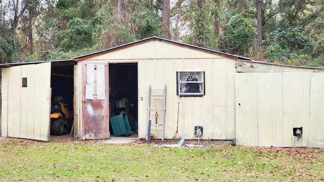 view of outbuilding featuring a lawn