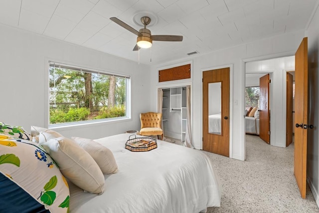 bedroom with ceiling fan and a closet