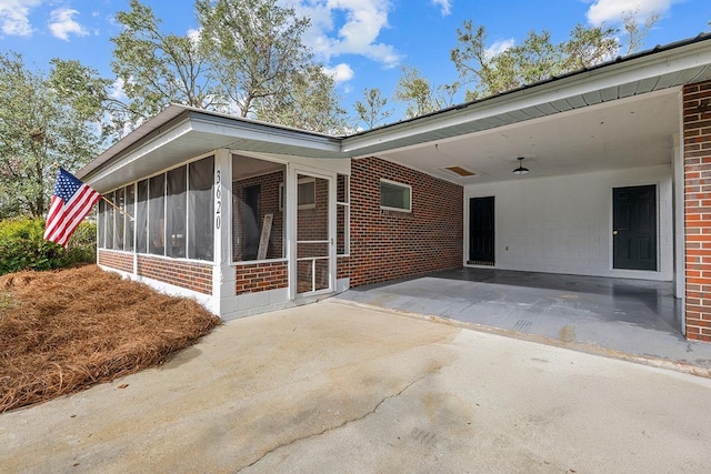 exterior space with a sunroom and a carport