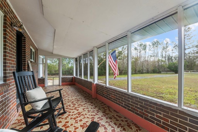 unfurnished sunroom featuring lofted ceiling