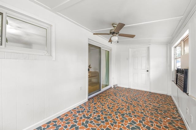 unfurnished sunroom with ceiling fan