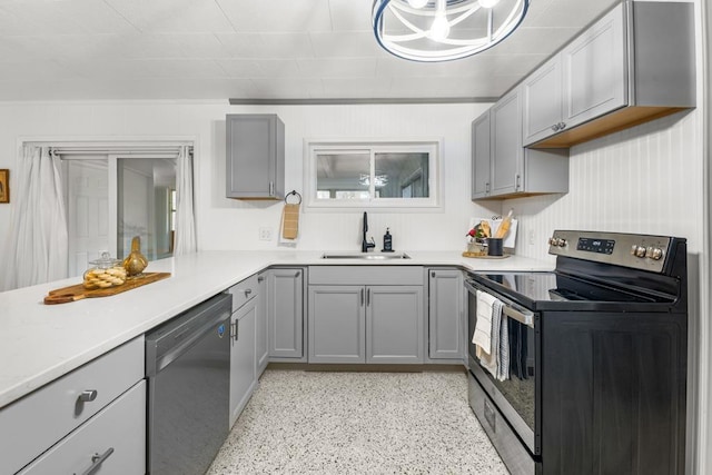 kitchen with gray cabinets, appliances with stainless steel finishes, and sink