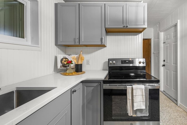 kitchen with gray cabinetry and electric stove