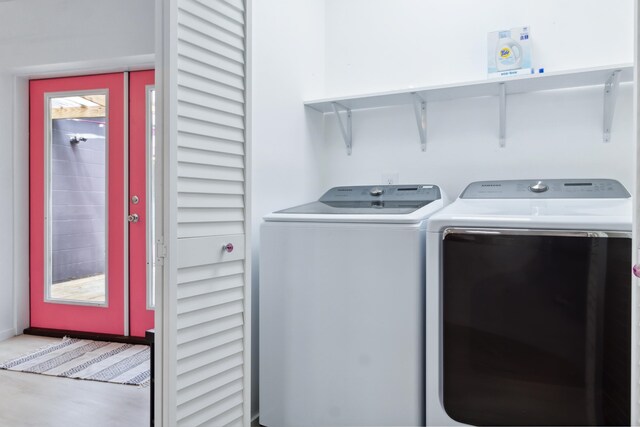 clothes washing area featuring separate washer and dryer