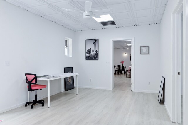 office with ceiling fan and light hardwood / wood-style flooring