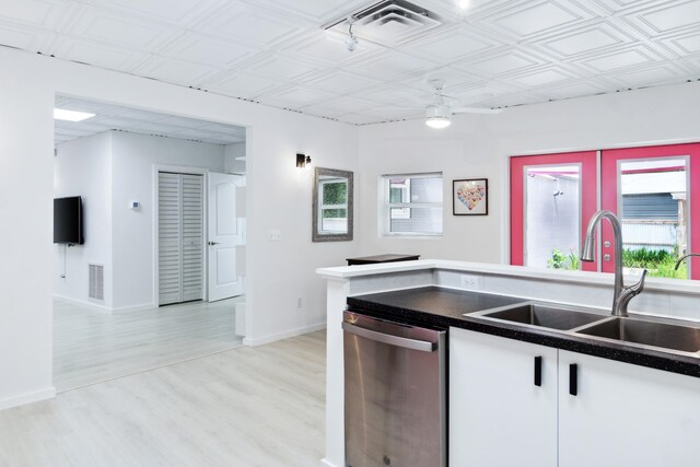 kitchen featuring dishwasher, light wood-type flooring, white cabinetry, and sink