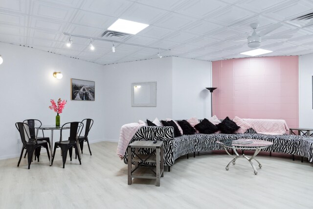 living room featuring ceiling fan, wood-type flooring, and track lighting