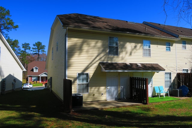 rear view of house featuring a patio area and a lawn