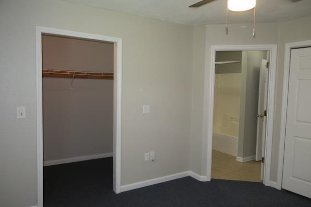 unfurnished bedroom with dark colored carpet