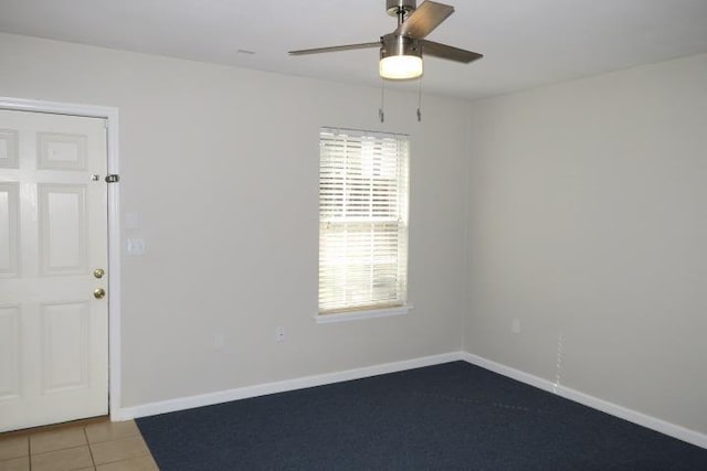 tiled empty room with ceiling fan