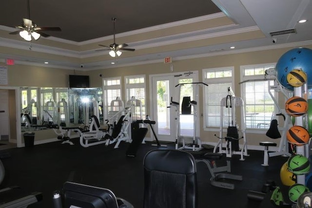 exercise room featuring ornamental molding, ceiling fan, and a tray ceiling