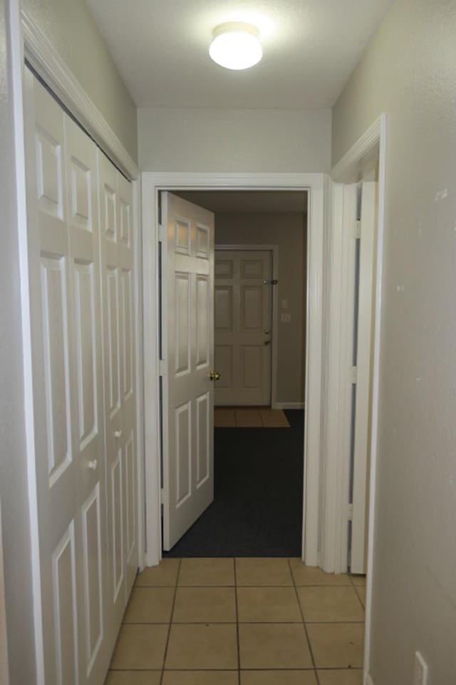 hallway with light tile patterned floors