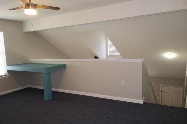 additional living space with ceiling fan, lofted ceiling, and dark carpet