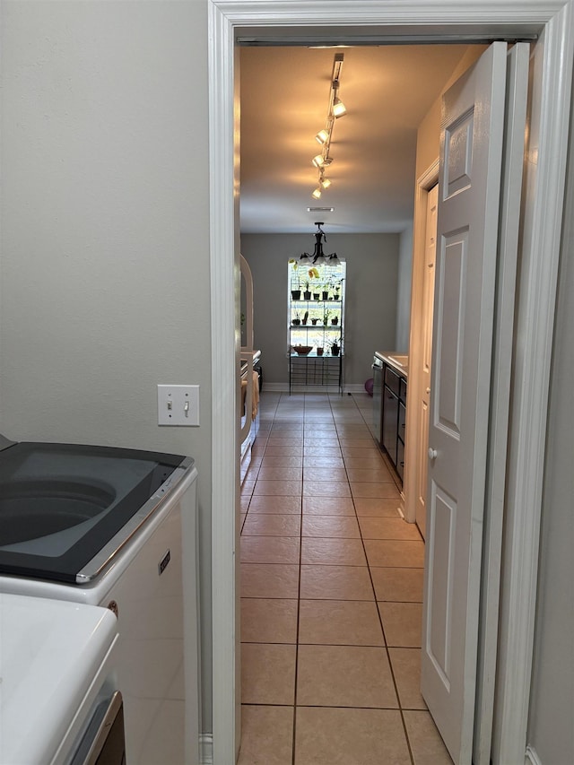 29 Chippewa Rd, Crawfordville, FL 32327 - laundry area with light tile patterned flooring, rail lighting, and separate washer and dryer