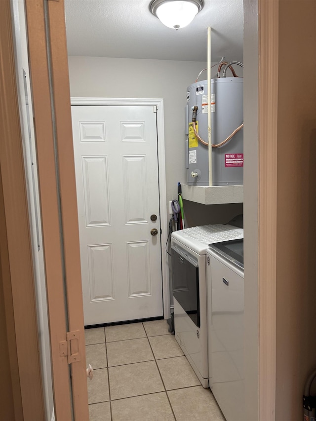 29 Chippewa Rd, Crawfordville, FL 32327 - laundry room with electric water heater, separate washer and dryer, and light tile patterned floors