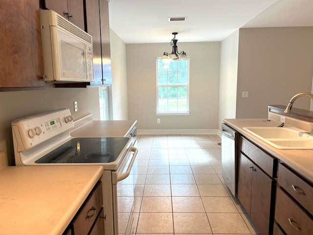29 Chippewa Rd, Crawfordville, FL 32327 - kitchen featuring white appliances, light countertops, hanging light fixtures, and light tile patterned flooring