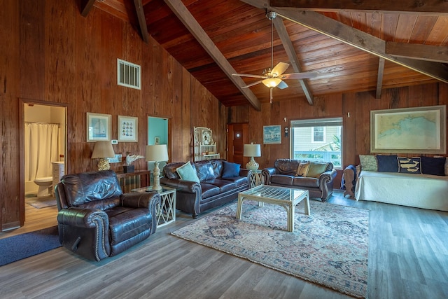 living room with hardwood / wood-style floors, beamed ceiling, ceiling fan, and wood ceiling