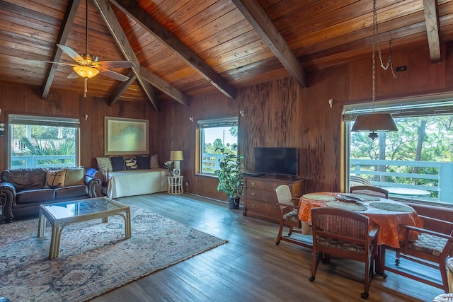 living room with a wealth of natural light, wood-type flooring, vaulted ceiling with beams, and wood ceiling