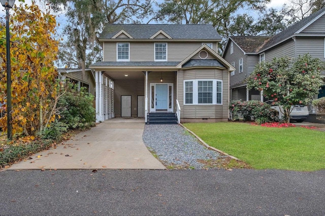 view of front of property with a front yard and a carport