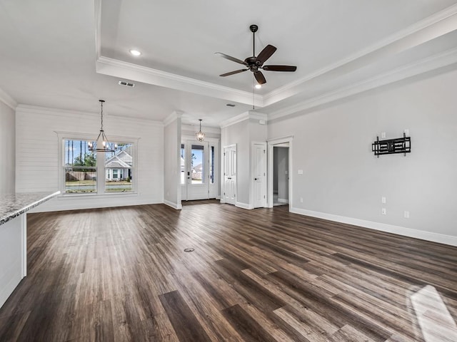 unfurnished living room with baseboards, visible vents, a raised ceiling, and dark wood finished floors