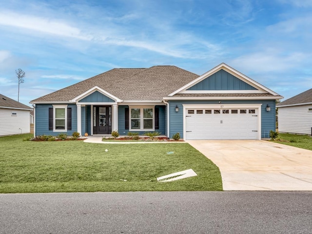 view of front of home with driveway, a garage, a shingled roof, board and batten siding, and a front yard