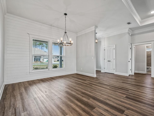 unfurnished dining area with ornamental molding, dark wood-style flooring, visible vents, and baseboards