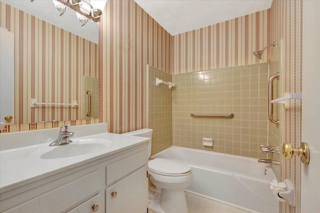 bathroom featuring tub / shower combination, vanity, toilet, and wallpapered walls