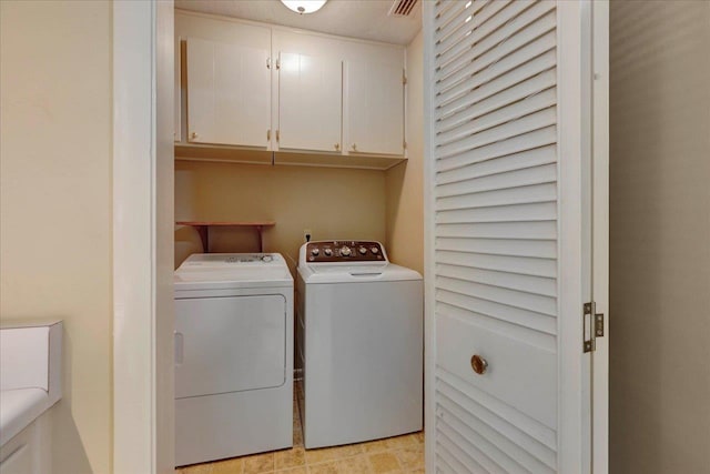 laundry room featuring cabinet space and washing machine and dryer