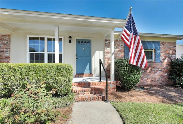 doorway to property with brick siding