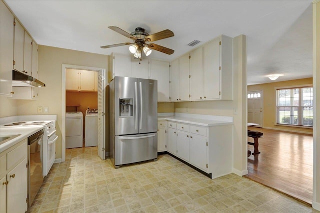 kitchen with light floors, stainless steel appliances, visible vents, independent washer and dryer, and under cabinet range hood